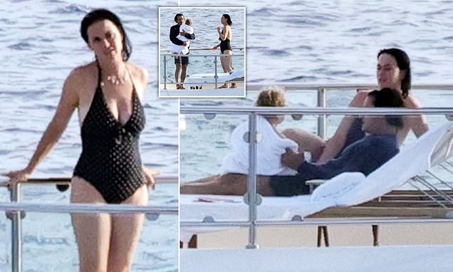 Katy Perry wows in a plunging black swimsuit as she spends quality time with family in Italy