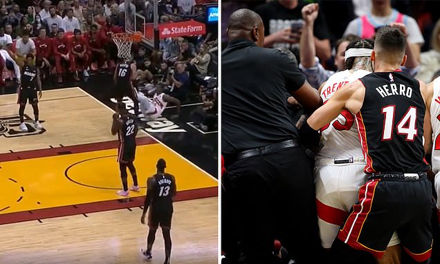 Caleb Martin tackles Christian Koloko into the STANDS before both are ejected during the Heat's win