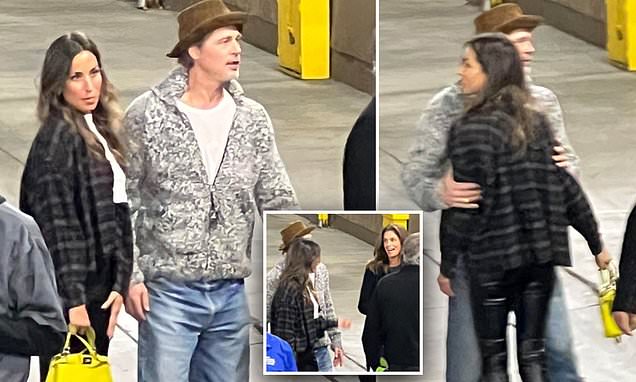 Brad Pitt gets up close and personal with Paul Wesley's ex wife at Bono concert